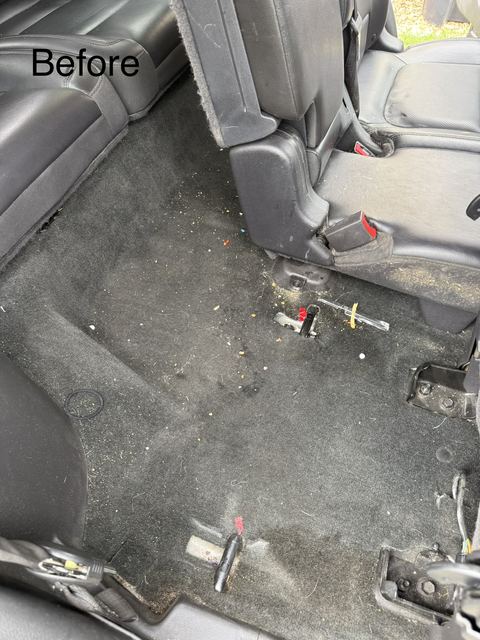 Dirty carpet and debris beneath black leather rear seats before detailing (labeled 'Before')