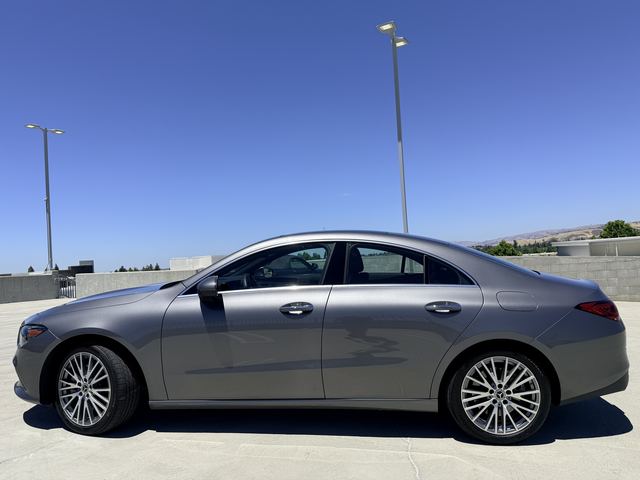 Gray Mercedes-Benz CLA in side profile on a rooftop parking deck
