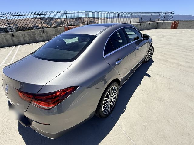 Gray Mercedes-Benz CLA, elevated rear three-quarter view on a rooftop parking deck