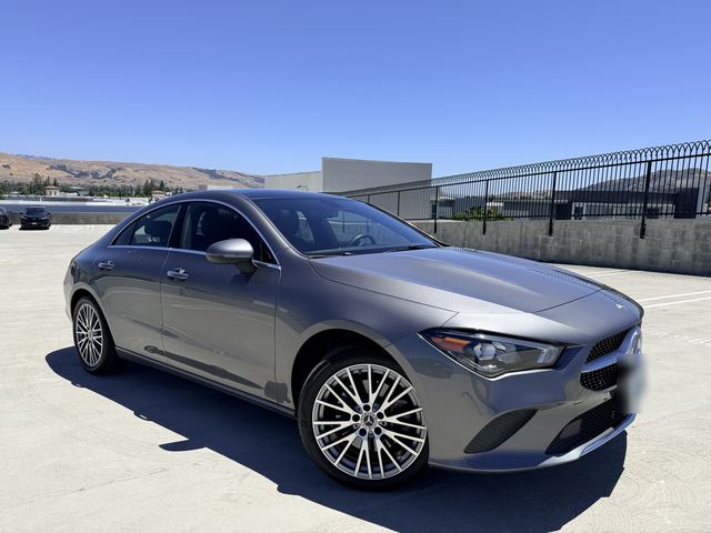 Gray Mercedes-Benz CLA, front three-quarter view on a rooftop parking deck