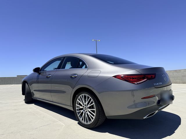 Gray Mercedes-Benz CLA 250, rear three-quarter view on a rooftop parking deck