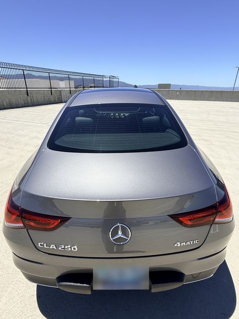 Gray Mercedes-Benz CLA 250 4MATIC, rear view on a rooftop parking deck