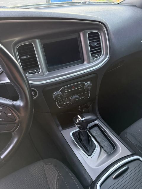 Car interior showing dashboard, touchscreen, climate controls and shifter