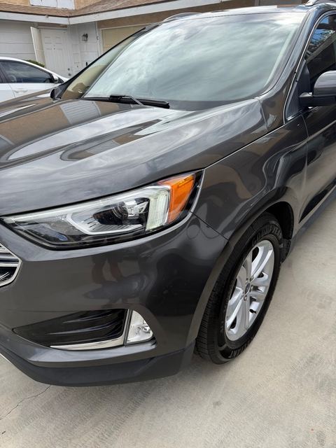Dark gray SUV front corner showing hood, headlight and alloy wheel