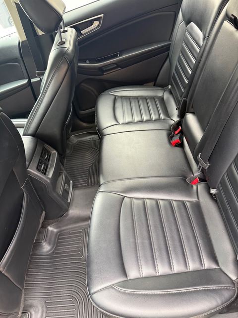 Black leather rear bench seat with rubber floor mats
