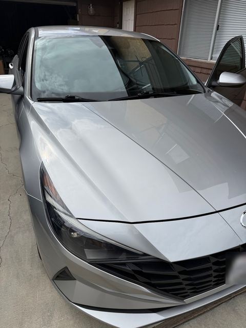 Silver sedan front three-quarter view in a driveway