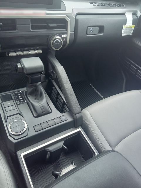 Toyota Tacoma center console with shifter, climate dials and cup holder